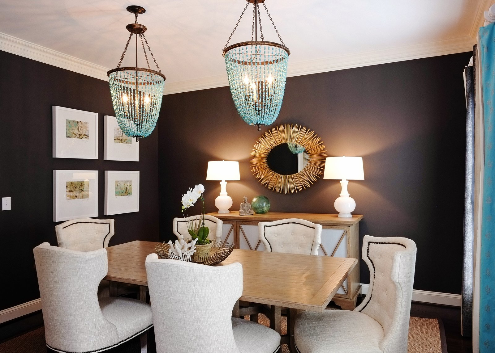 Bluff Run dining room with chocolate walls, aqua glass pendants and a sunburst mirror