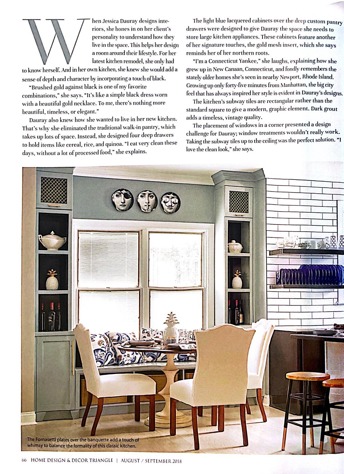 Magazine page with a banquette beneath three decorative plates, flanked by blue lacquered cabinets with gold mesh inserts