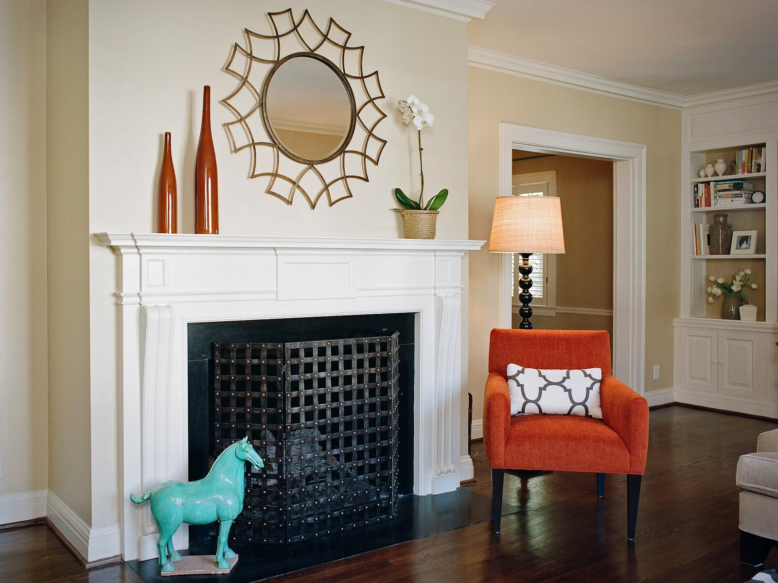 Irving Park living room with a sunburst mirror over a white mantel and a coral accent chair
