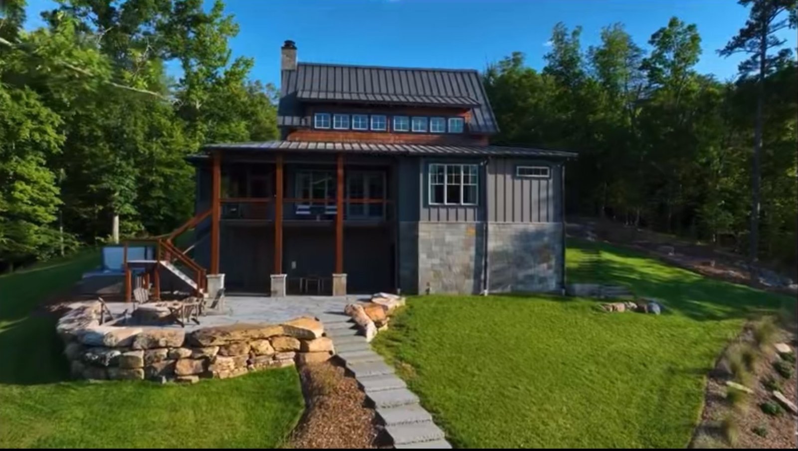 New construction lake house on Hyco Lake, North Carolina, with a stone terrace, fire pit and sweeping lawn