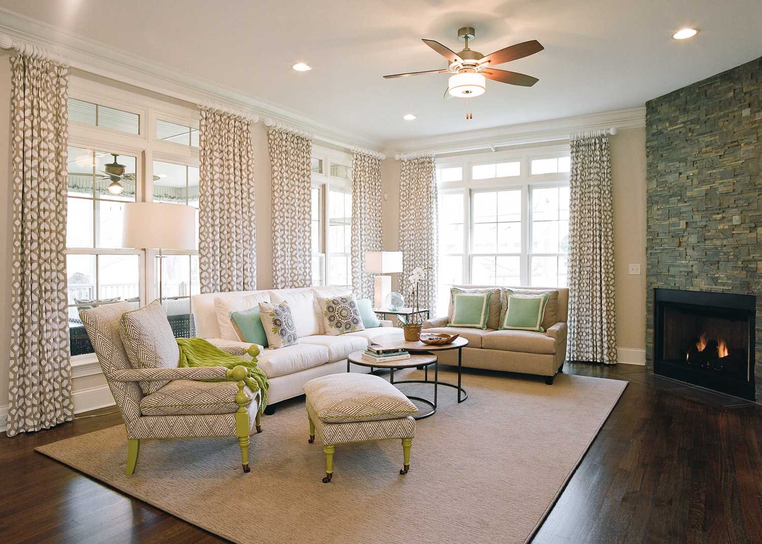New Irving Park family room with patterned drapery, a stacked-stone fireplace wall and soft upholstered seating
